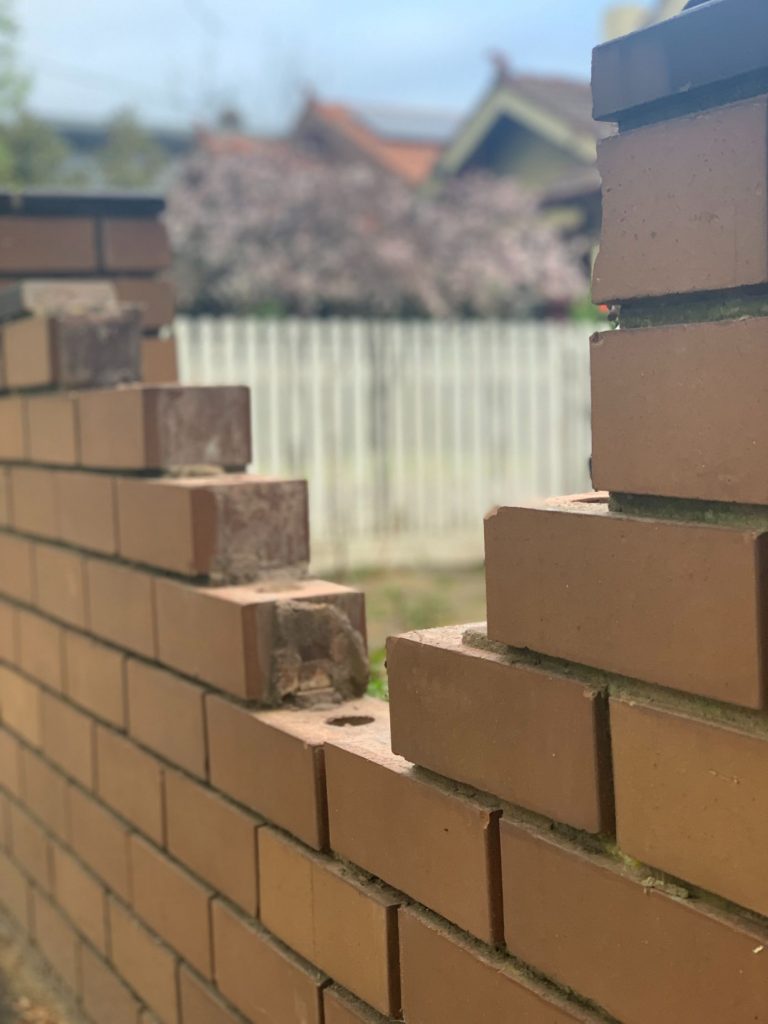 Photo of a brick fence needing brick repairs on The Sunshine Coast