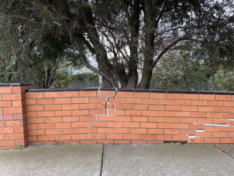 Bricklayers on The Sunshine Coast doing repairs on a brick fence