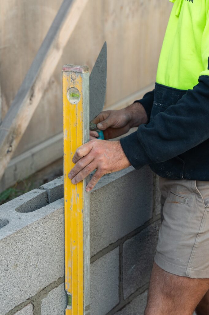Block retaining wall being levelled for a straight structural wall