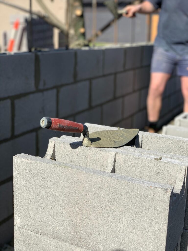 Block wall being laid above a prepared footing
