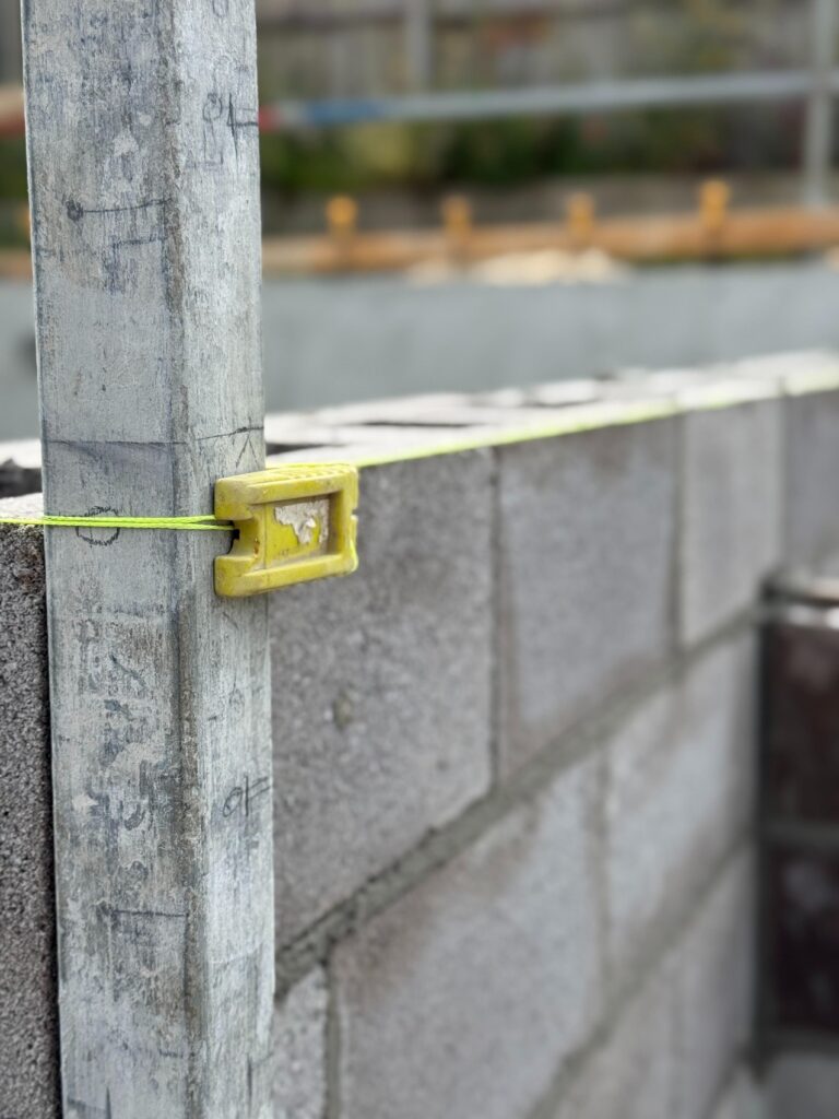 Block wall set out with string line for builder blocklaying work