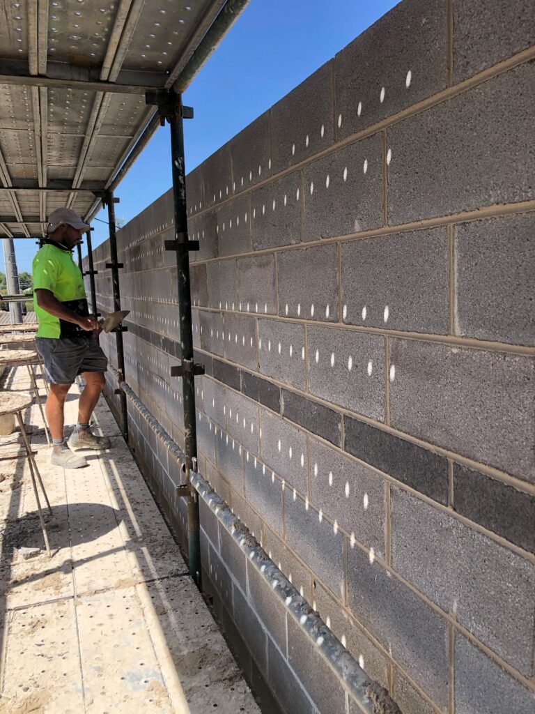 Long block wall run built from a straight footing