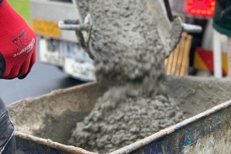 A concrete being poured in a wheelbarrow to be used for the brick fence footing in Coloundra